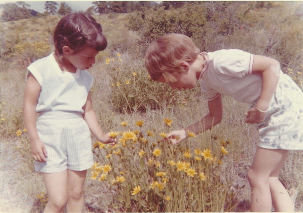 Vivienne and DIna inspect flowers in shorty shorts